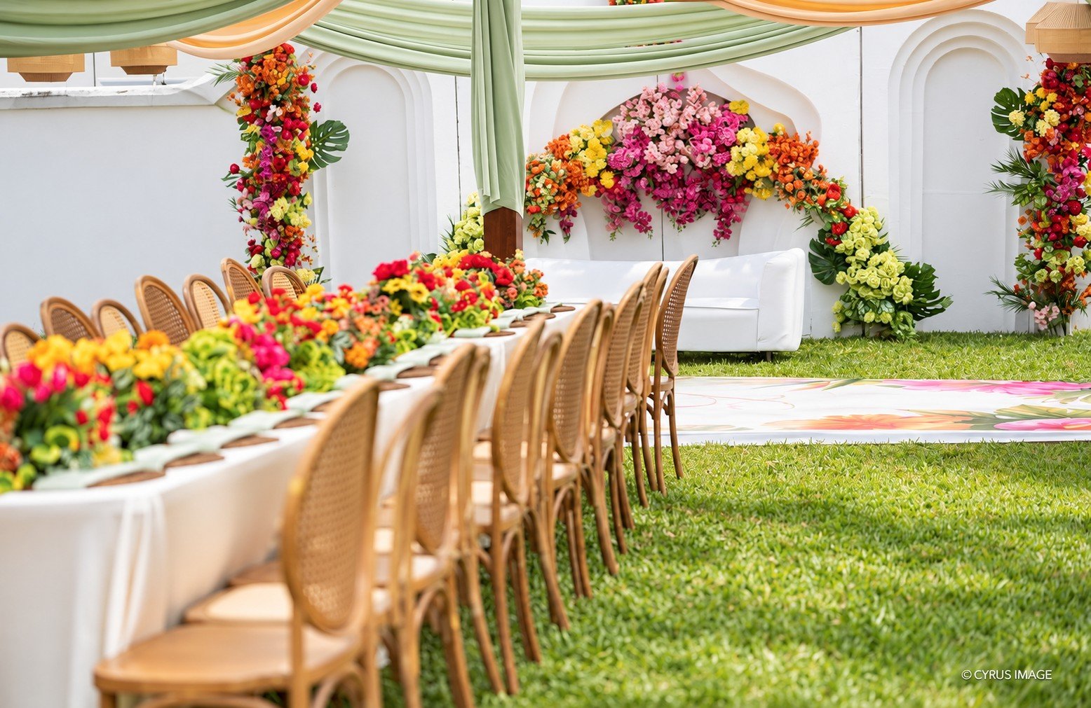 Colourful flowers, woven chairs and a dressed celebration table at Donna’s Place