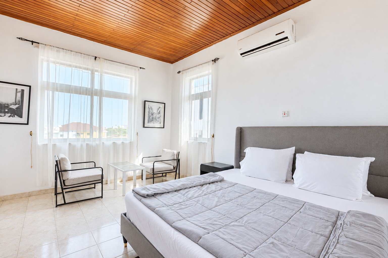 An on-site guest room at Donna’s Place with a double bed and seating
